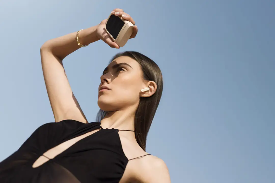 Woman holding Urbanista Phoenix desert colour solar powered lifestyle image