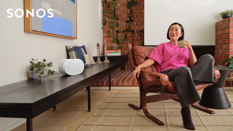 sonos brand header woman seated in living room listening to Era 300 speaker