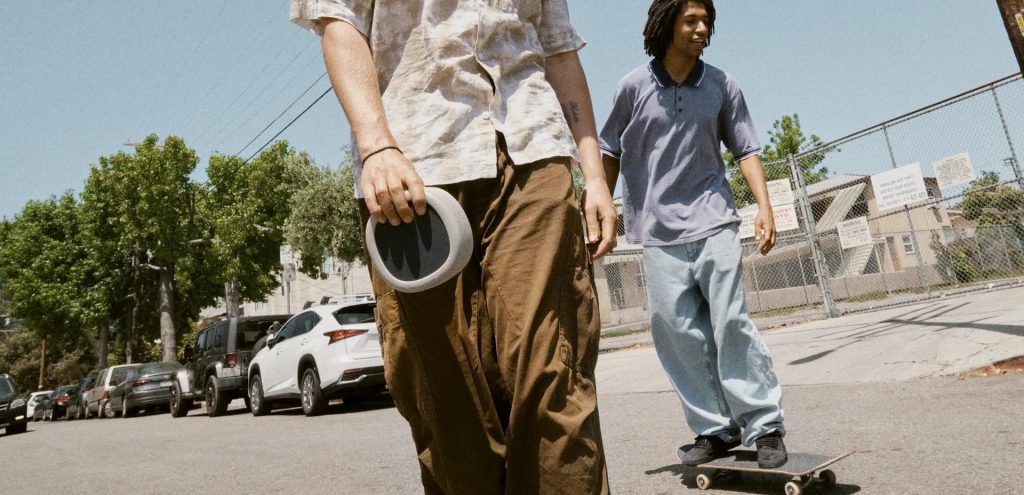 Two guys skateboarding carrying Urbanista Malibu in desert grey colour