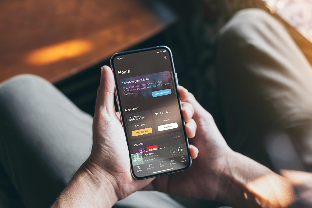 A person holding a phone with the Blu OS App on the screen.