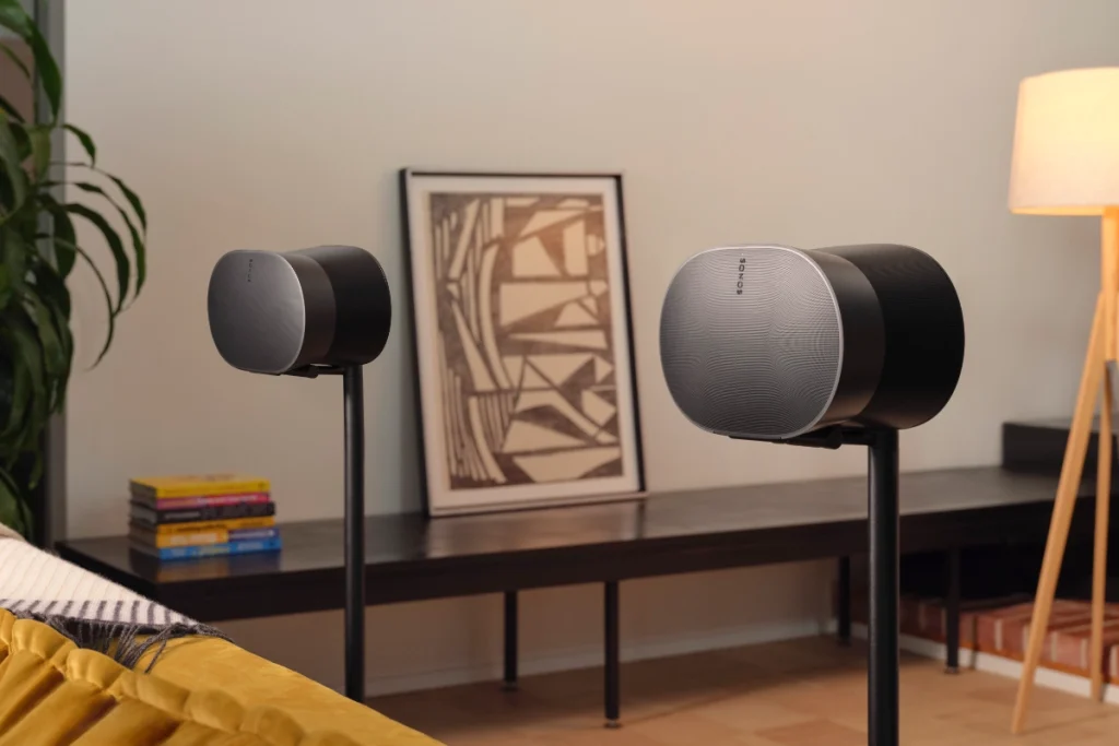 Sonos Immersive Music Set with Era 300 Stereo Pair, mounted on two speaker stands behind a couch, in a cozy living room
