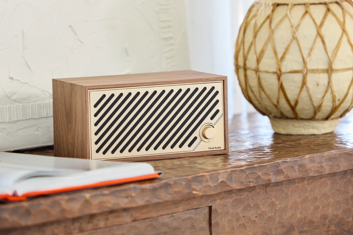 Tivoli Model Two Digital in walnut, gold, MCM, resting on dresser beside book and flower pot