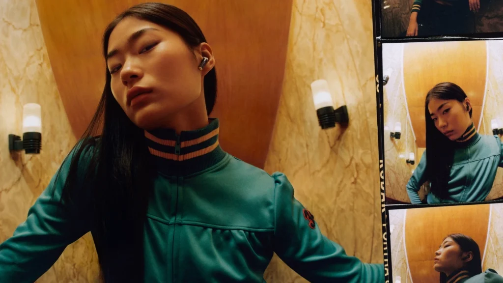 Woman wearing Marshall Earphones in green jumpsuit, film photos