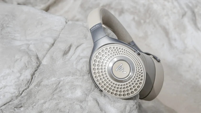 Focal Bathys Headphones resting on a rock, matching the dune colourway