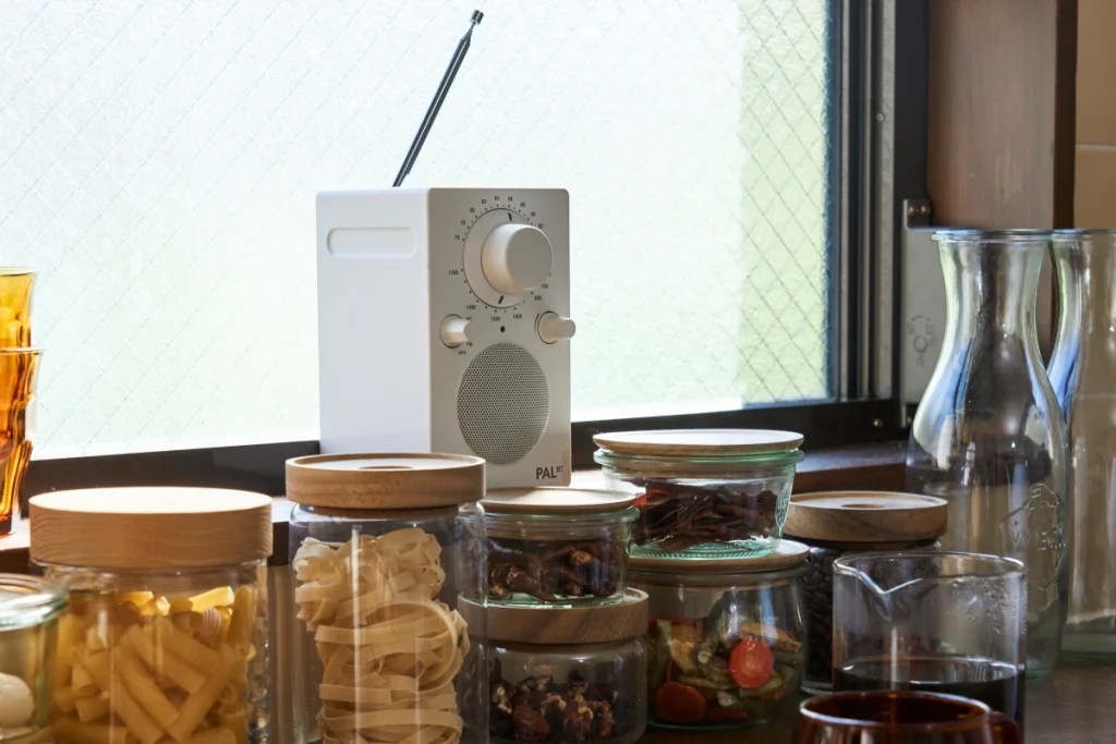 Tivoli Pal BT Speaker in white sits on a busy kitchen counter