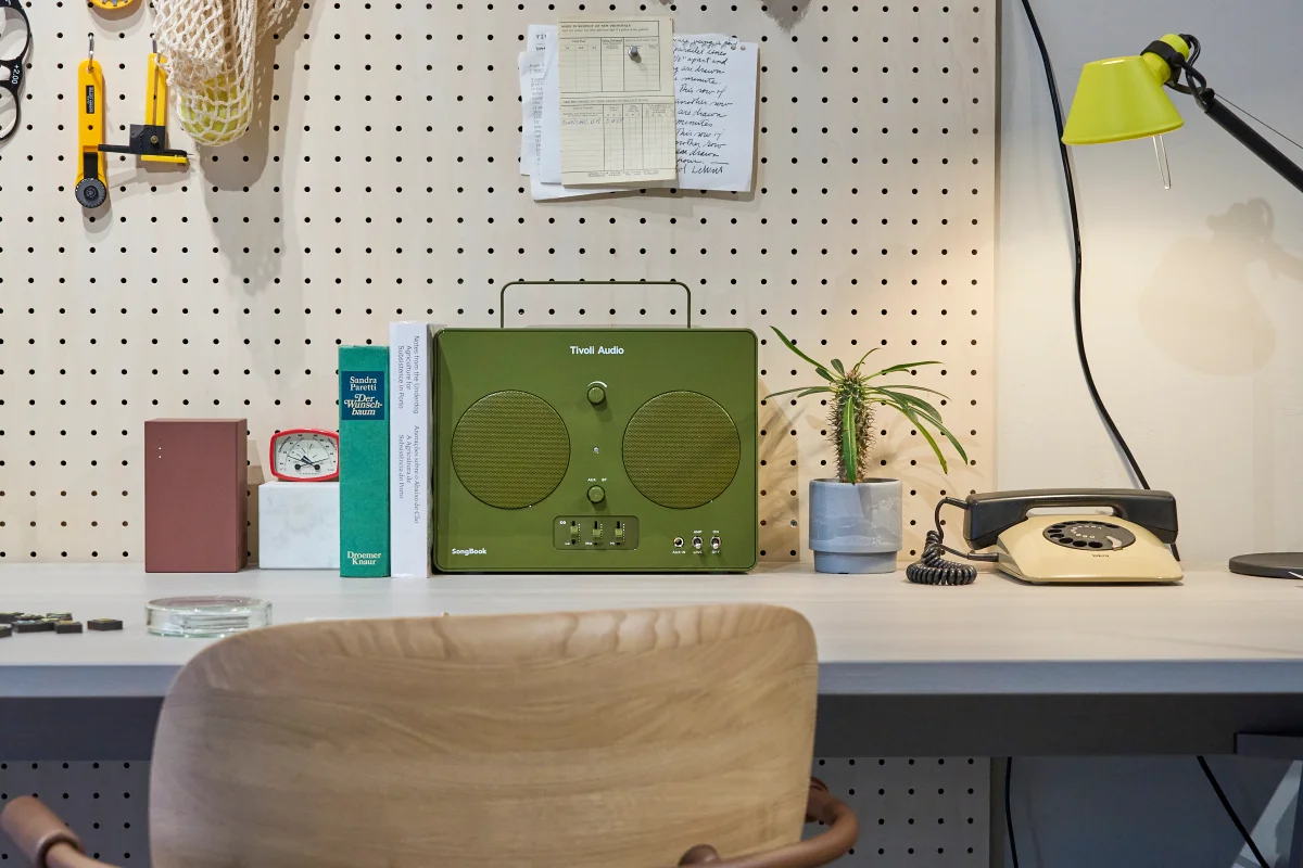 Tivoli Songbook in Green, resting on an artistic desktop workspace