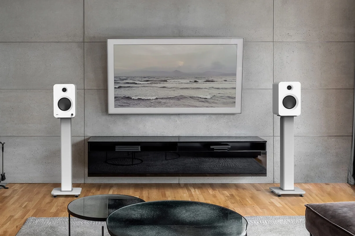 Kanto REN speakers in matte white on white speaker stands beside credenza and TV