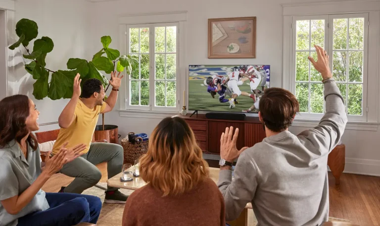People watching a football game in a living room