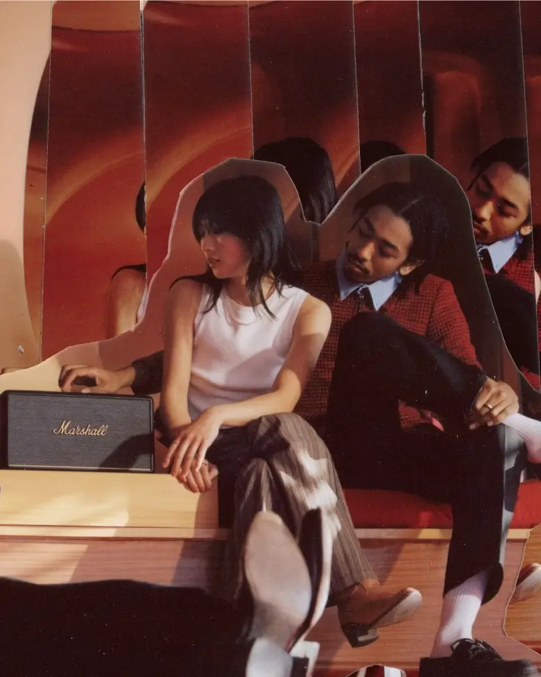 A couple sitting next to a Marshall Stanmore III bluetooth speaker in very cool room