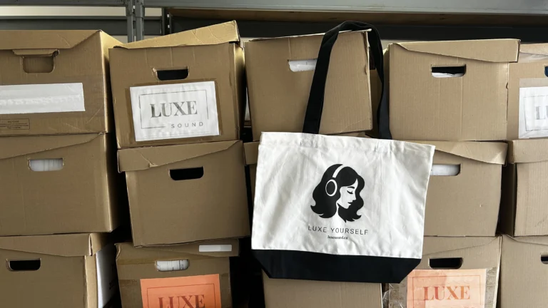 Luxe Sound tote bag on luxe sound branded boxes, lifestyle photo
