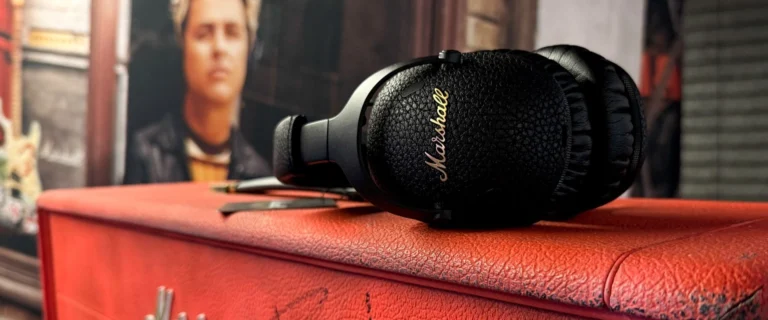 Marshall Noise cancelling headphones resting on top of marshall amp